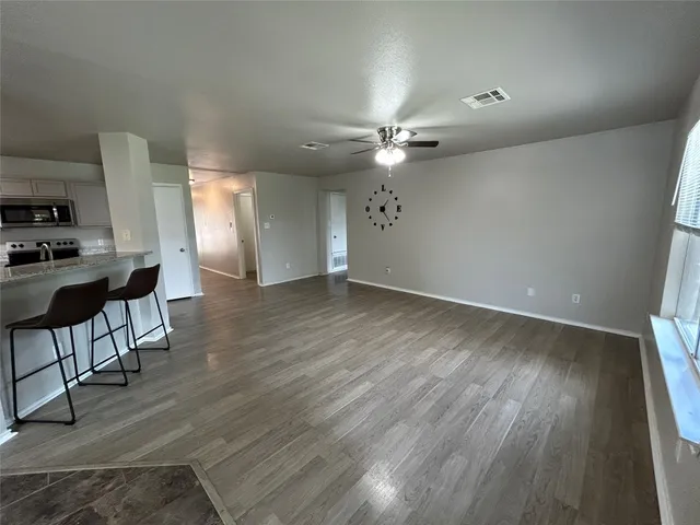 a view of a kitchen with microwave and cabinets