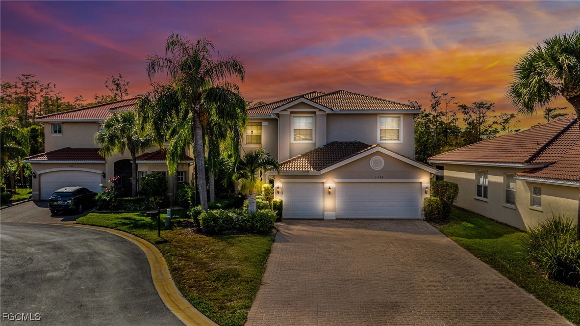 11196 Sand Pine Court Fort Myers, FL 33913 - Photo 1 of 49 a front view of a house with a yard and a garage