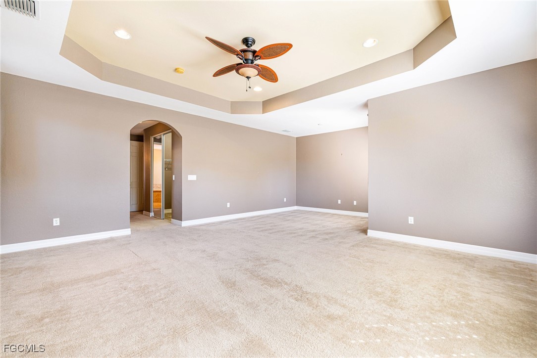 11196 Sand Pine Court Fort Myers, FL 33913 - Photo 14 of 49 a view of an empty room with a ceiling fan