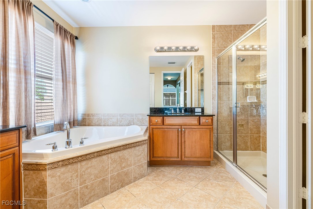 11196 Sand Pine Court Fort Myers, FL 33913 - Photo 16 of 49 a bathroom with a bathtub and a sink