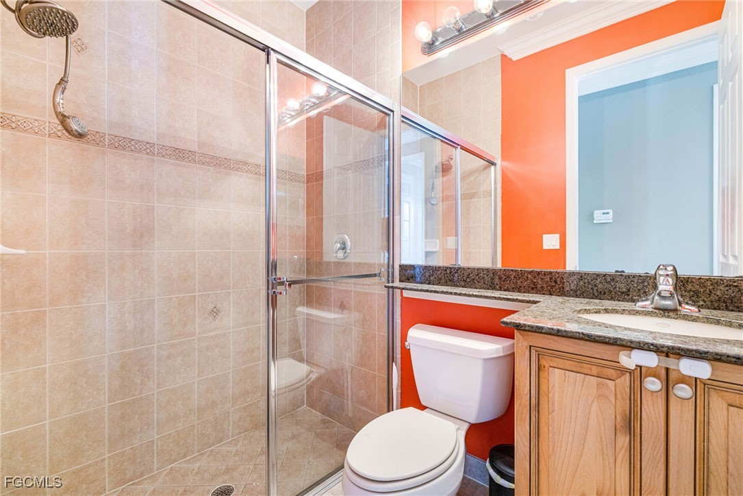 11196 Sand Pine Court Fort Myers, FL 33913 - Photo 21 of 49 a bathroom with a granite countertop sink toilet and shower