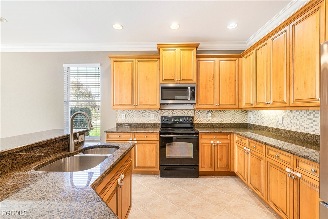 11196 Sand Pine Court Fort Myers, FL 33913 - Photo 7 of 49 a kitchen with stainless steel appliances granite countertop a sink stove and cabinets