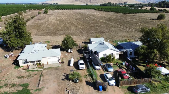 an aerial view of a house with outdoor space and lake view