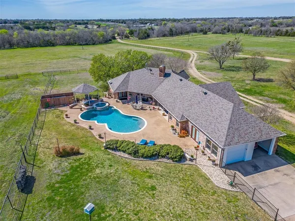 an aerial view of a house with outdoor space