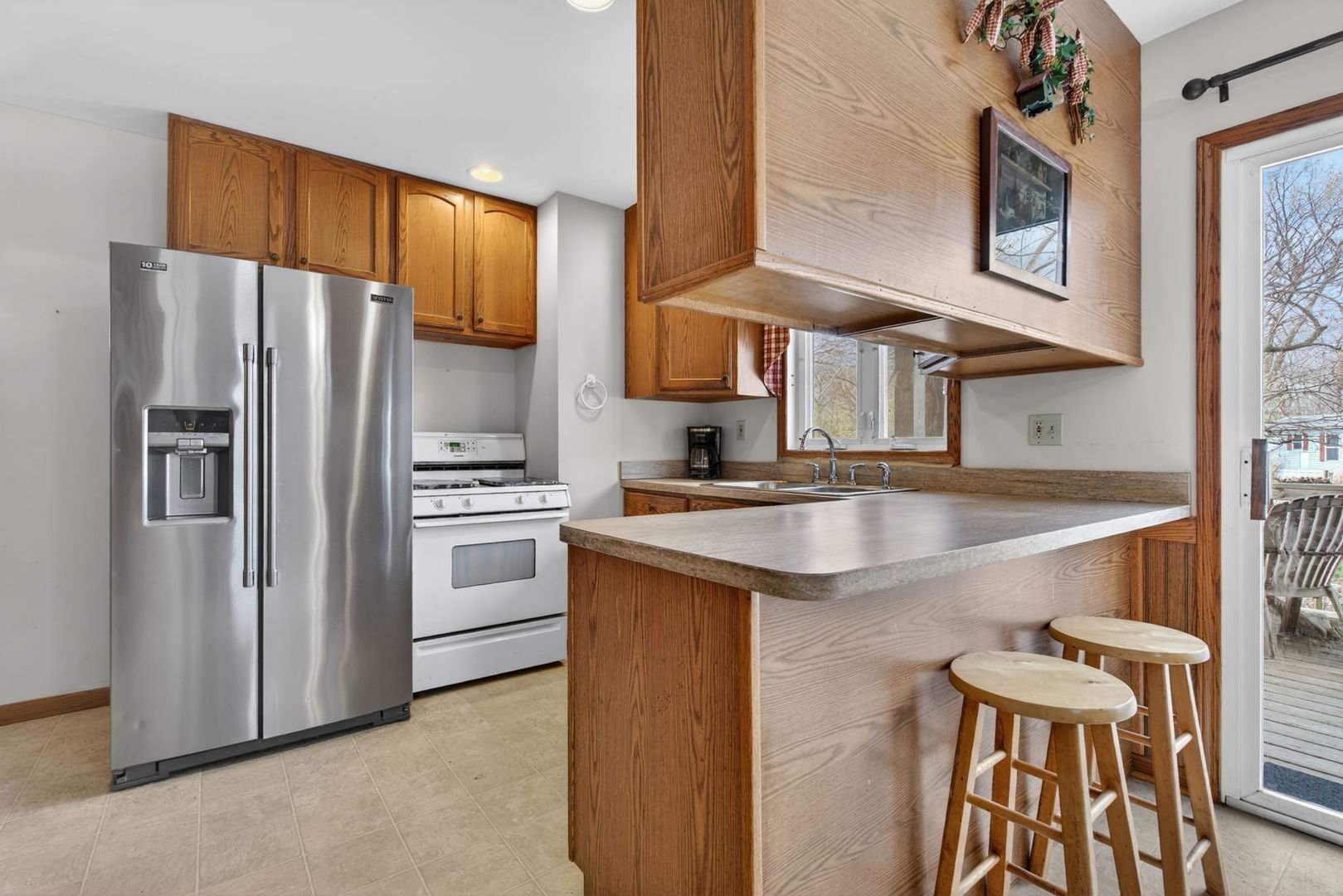 1 Largemouth Lane Wilmington, IL 60481 - Photo 12 of 47 a kitchen with stainless steel appliances granite countertop a refrigerator a stove and a sink