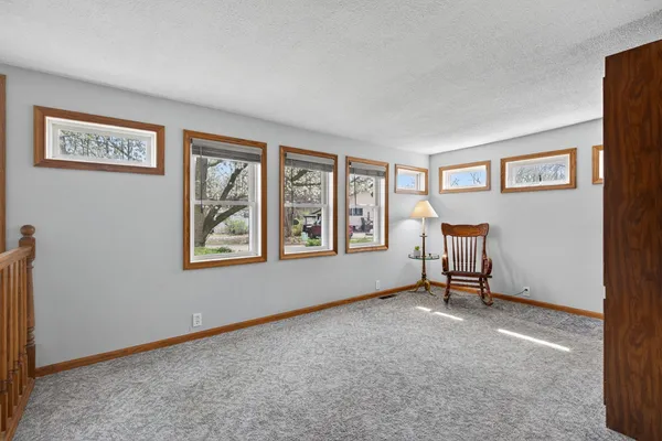 a living room with furniture and a chair