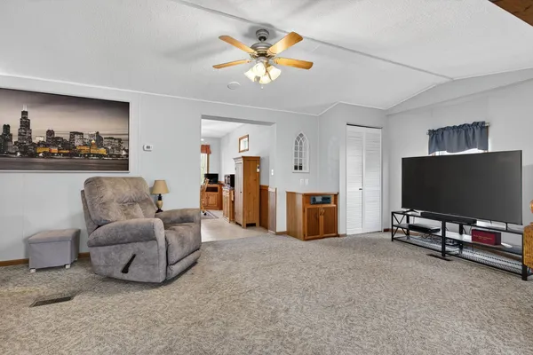 a kitchen with stainless steel appliances granite countertop a refrigerator a stove and a sink