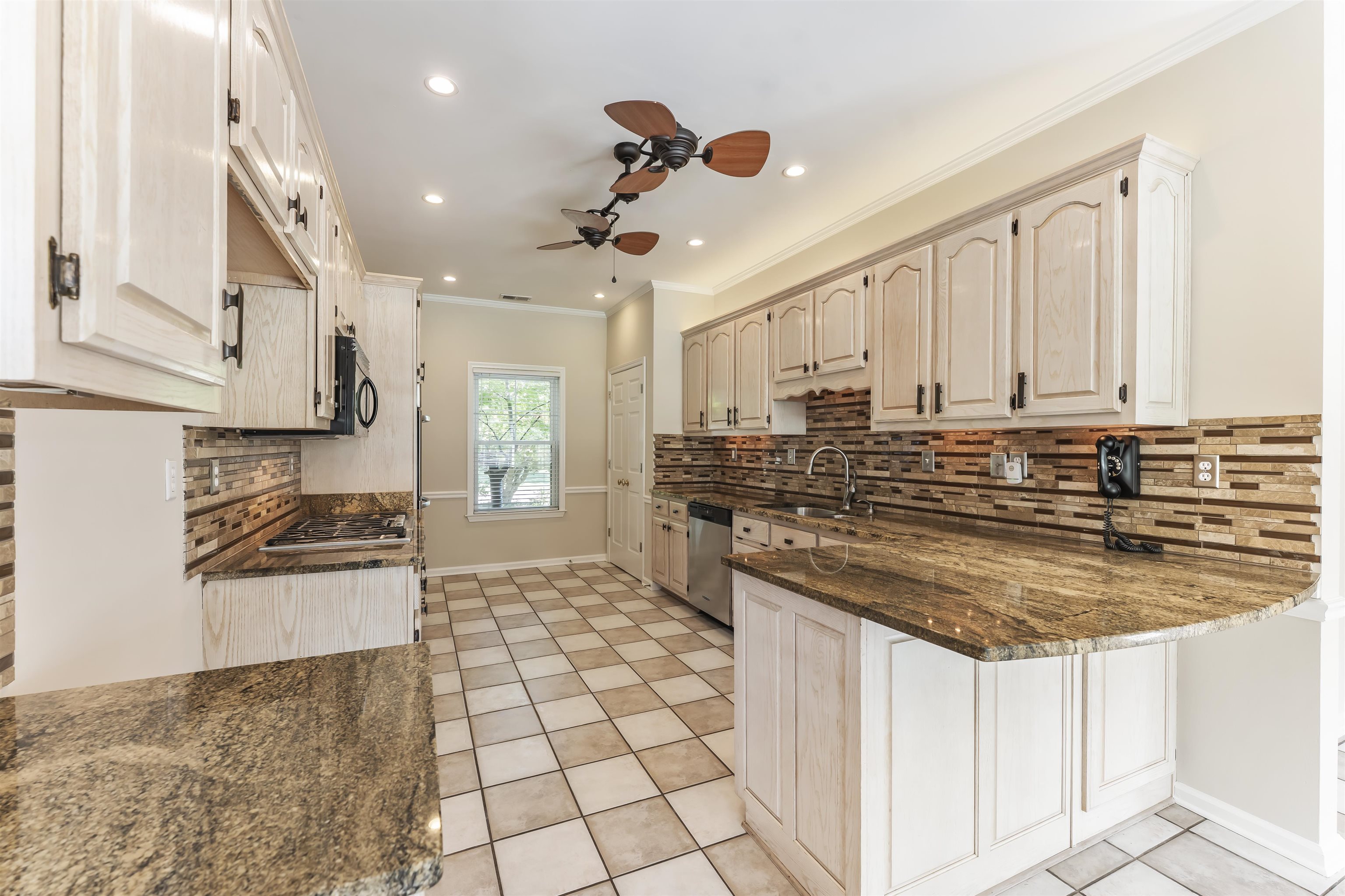 4279 High Plains Road Bartlett, TN 38135 - Photo 3 of 37 Kitchen featuring ample light-toned cabinetry, granite countertops, a decorative tile backsplash, recessed lighting, and checkerboard floor tiling