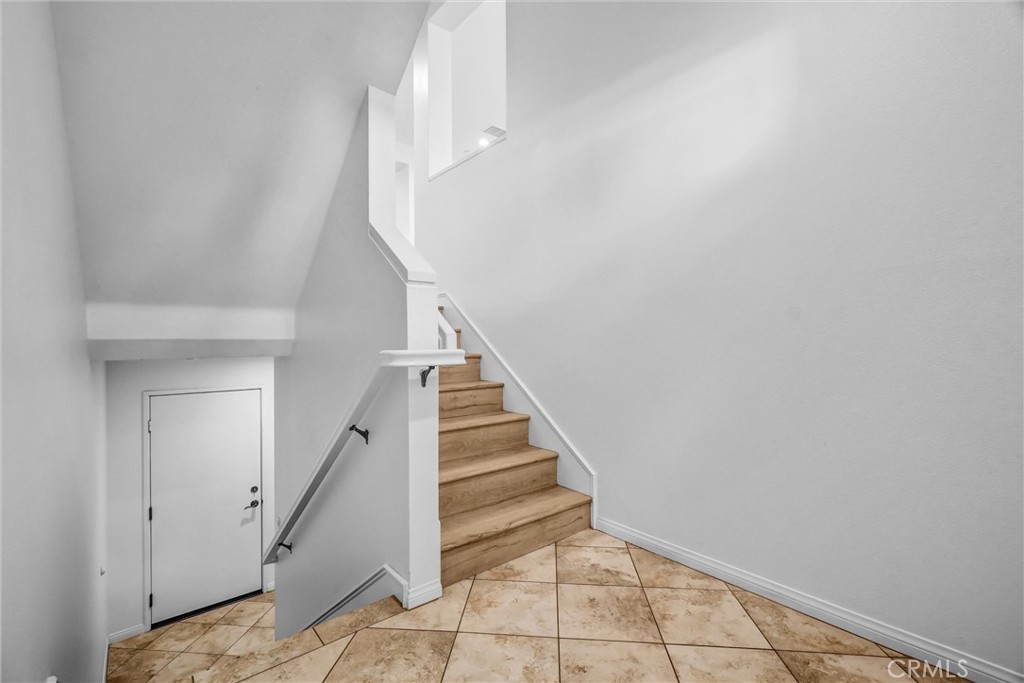 12 Shellprint Court Newport Beach, CA 92663 - Photo 22 of 42 Front door leads to main level and to upstairs bedrooms 1,2,and 3 downstairs to 4th bedroom.