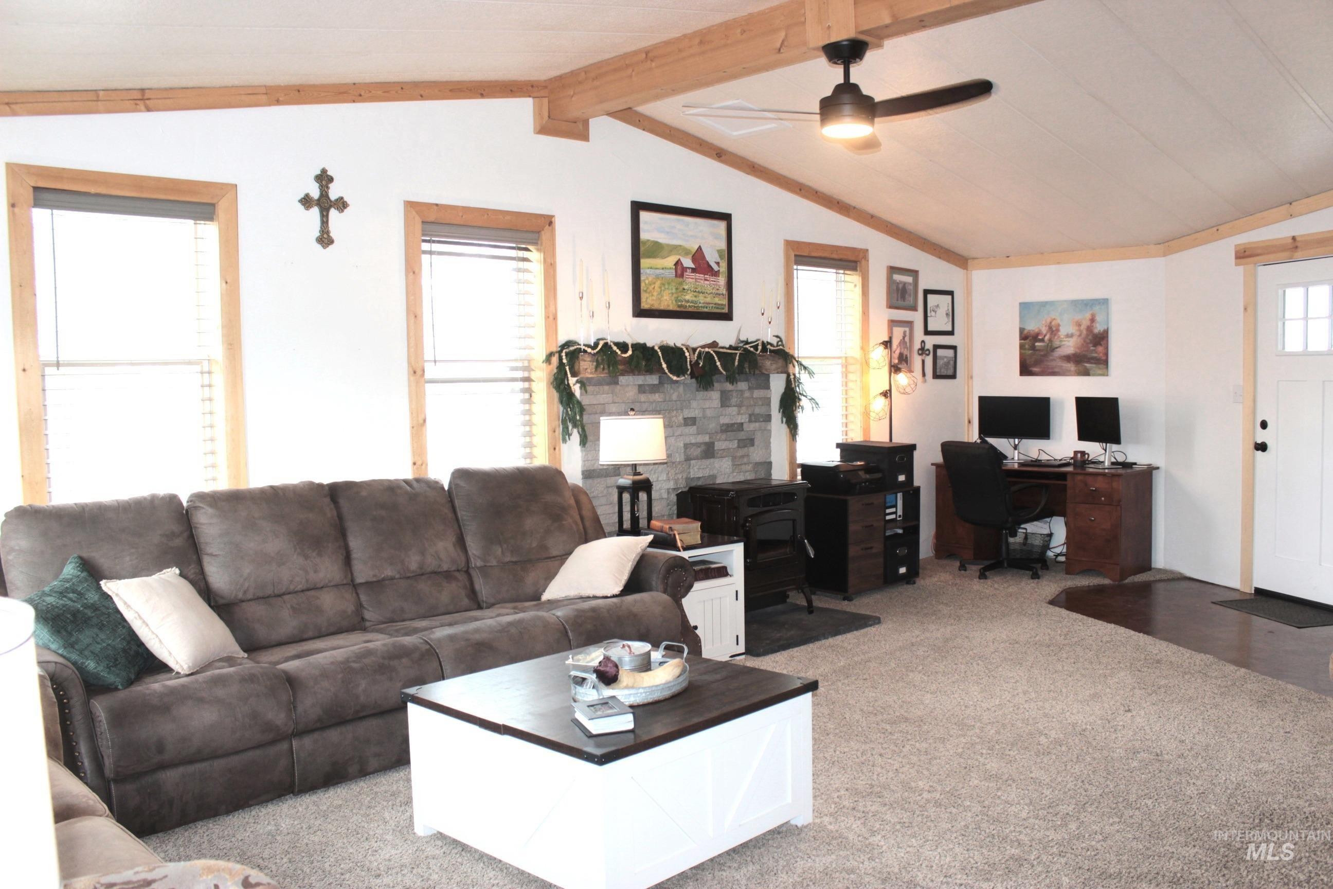 1824 Dutch Flat Road Midvale, ID 83645 - Photo 7 of 39 Carpeted living room with an office area, a ceiling fan, and beamed ceiling
