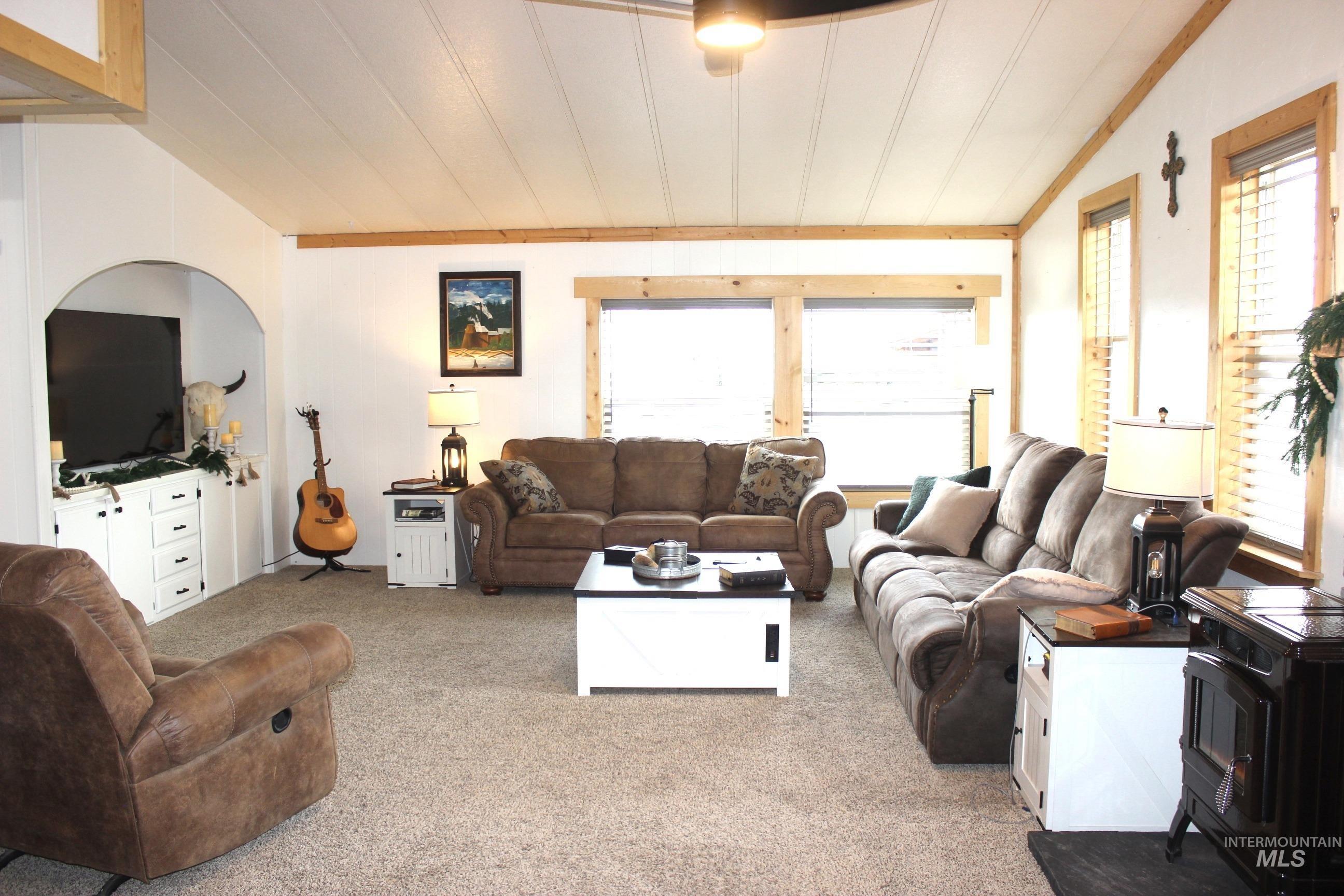 1824 Dutch Flat Road Midvale, ID 83645 - Photo 8 of 39 Living room featuring vaulted ceiling, plenty of natural light, light colored carpet, and crown molding