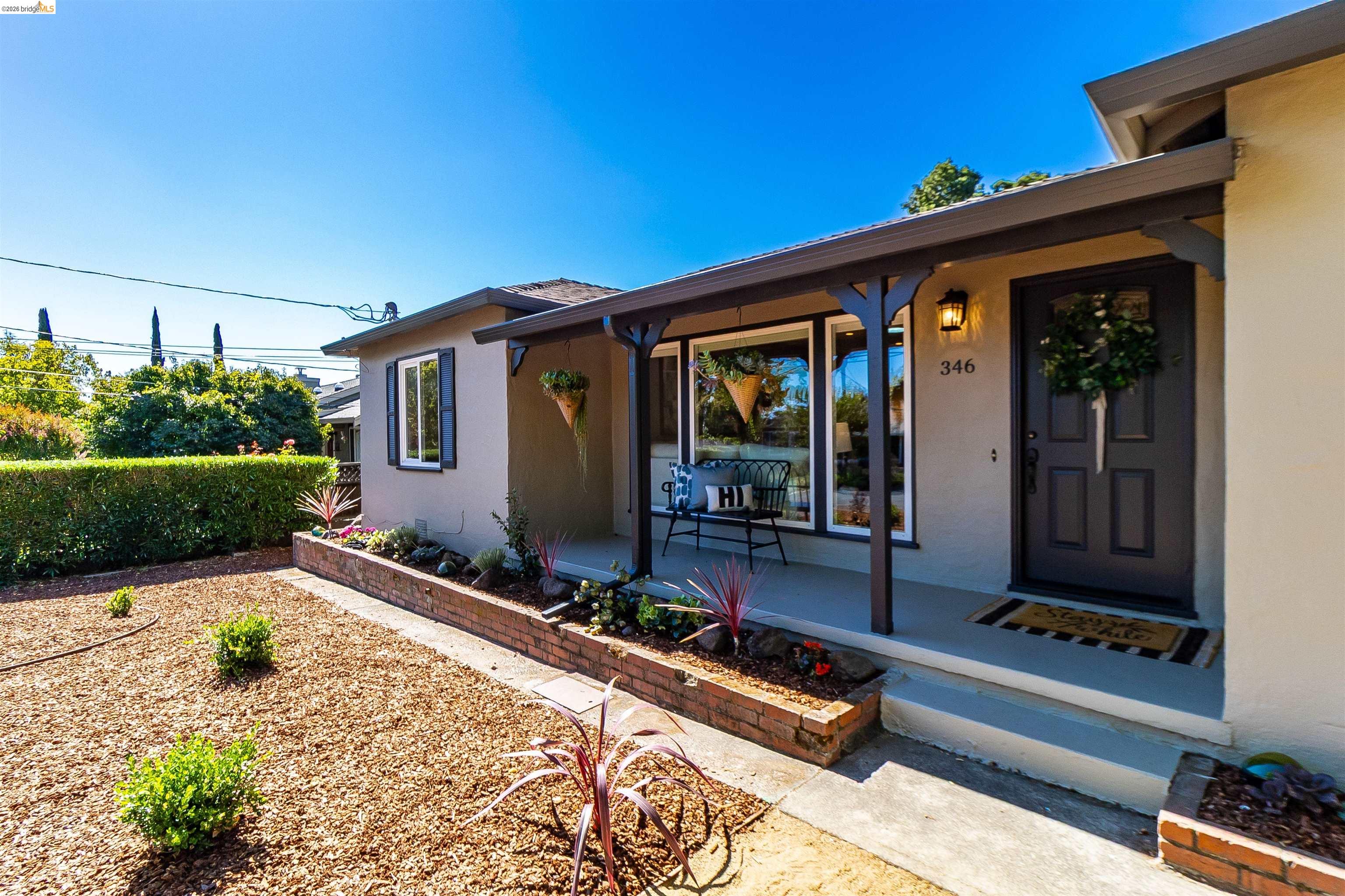 346 Valley View Road Pleasant Hill, CA 94523 - Photo 5 of 57 Front entry featuring a dark-toned door, covered porch, and exposed rafter tails