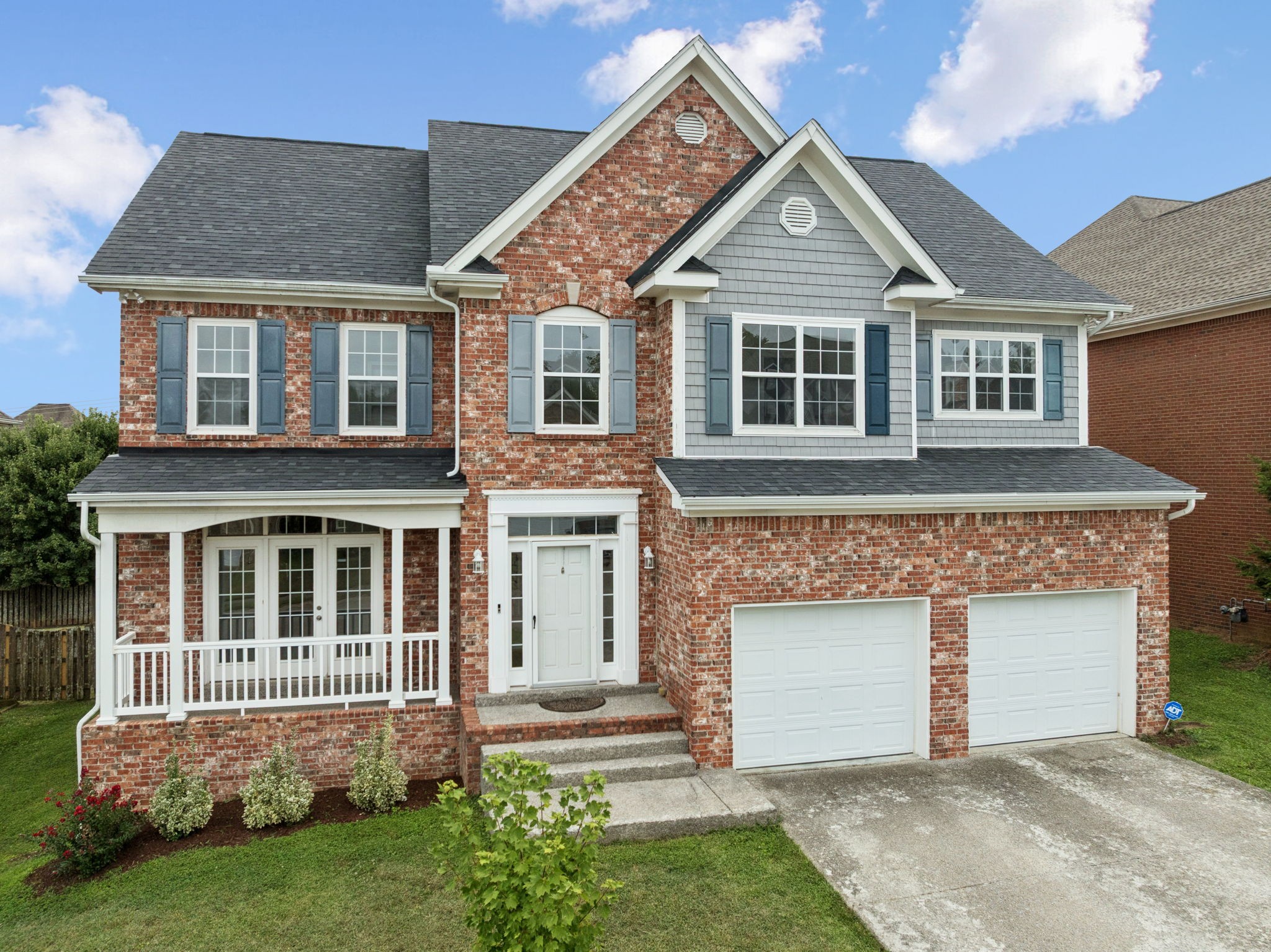 a front view of a house with a garden
