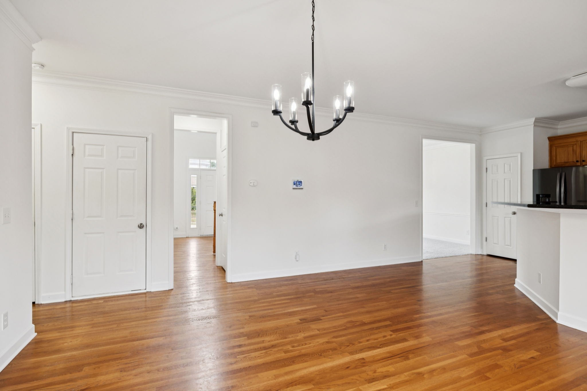 2015 Keene Circle Spring Hill, TN 37174 - Photo 11 of 37 a view of an empty room with wooden floor and kitchen view