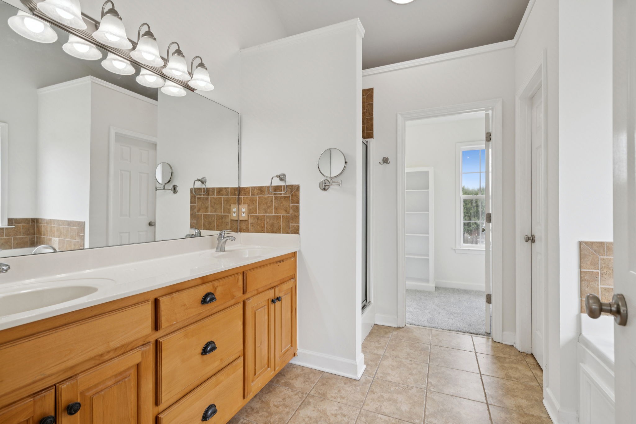 2015 Keene Circle Spring Hill, TN 37174 - Photo 19 of 37 a spacious bathroom with a granite countertop sink a mirror and a shower