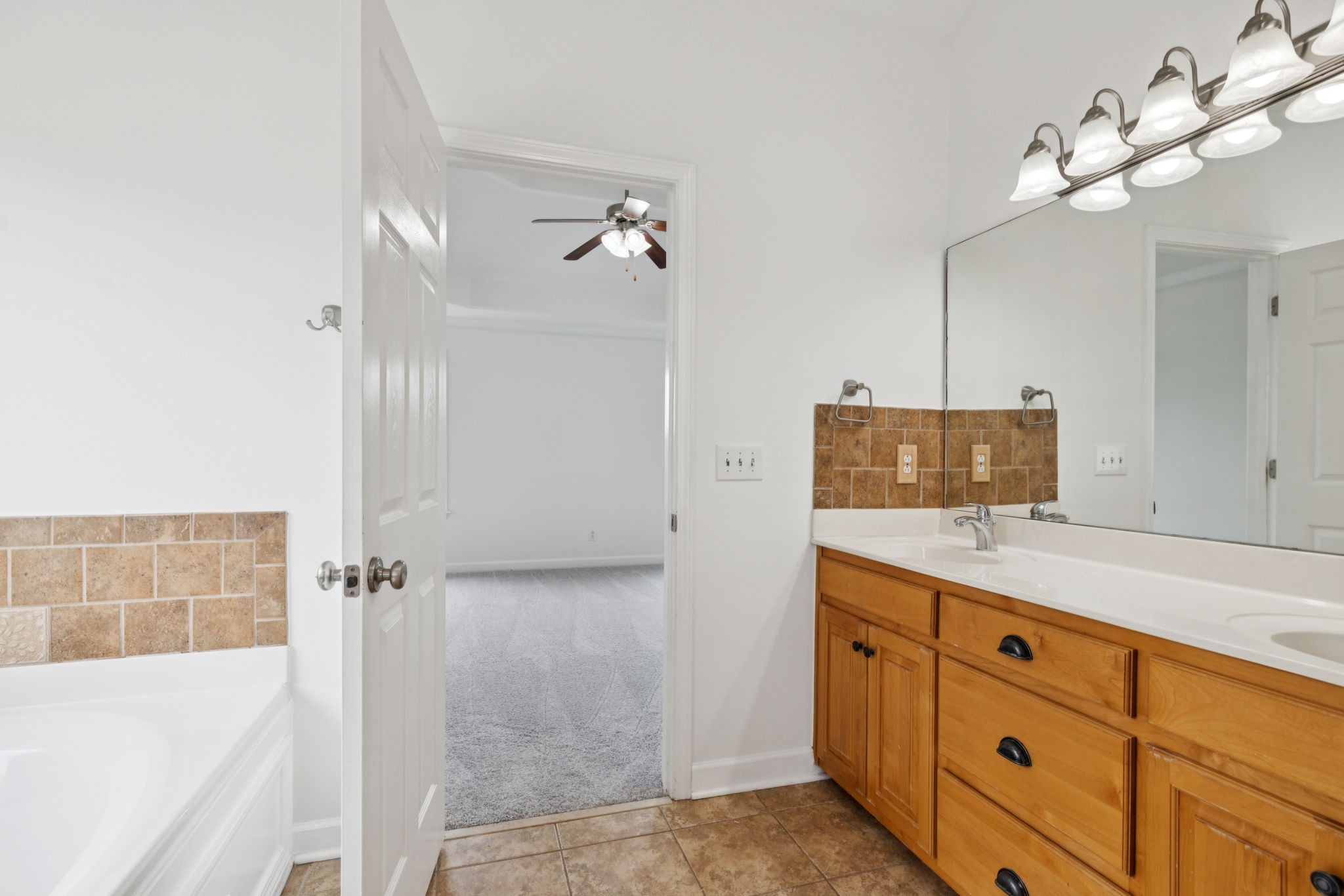 2015 Keene Circle Spring Hill, TN 37174 - Photo 20 of 37 a bathroom with a double vanity sink a mirror and a shower