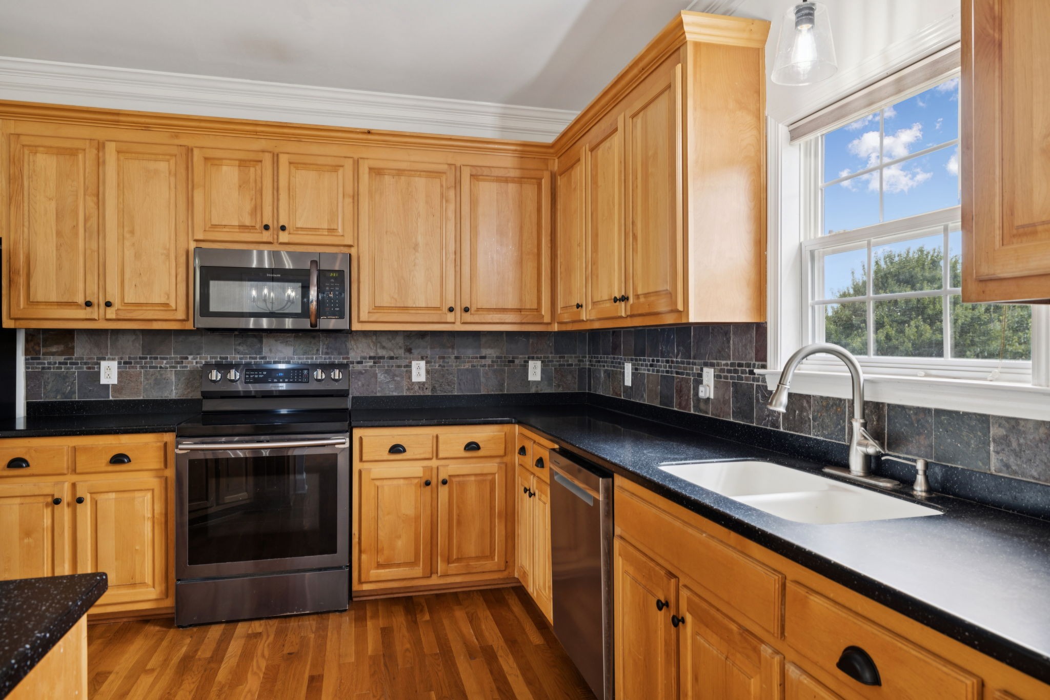 2015 Keene Circle Spring Hill, TN 37174 - Photo 7 of 37 a kitchen with stainless steel appliances granite countertop a stove a sink and a white cabinets