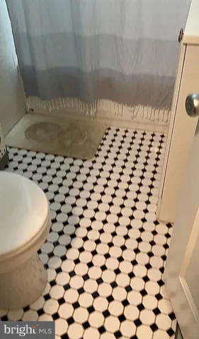 a view of a bedroom with closet and mirror