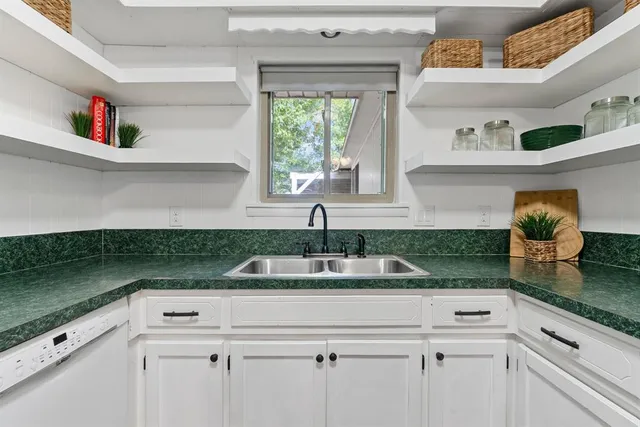 a kitchen with a sink and cabinets