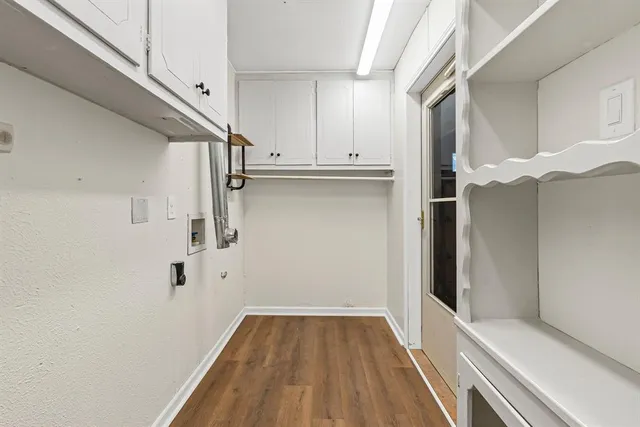 a view of walk in closet with wooden floor