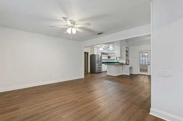 a view of a kitchen with a sink and a refrigerator