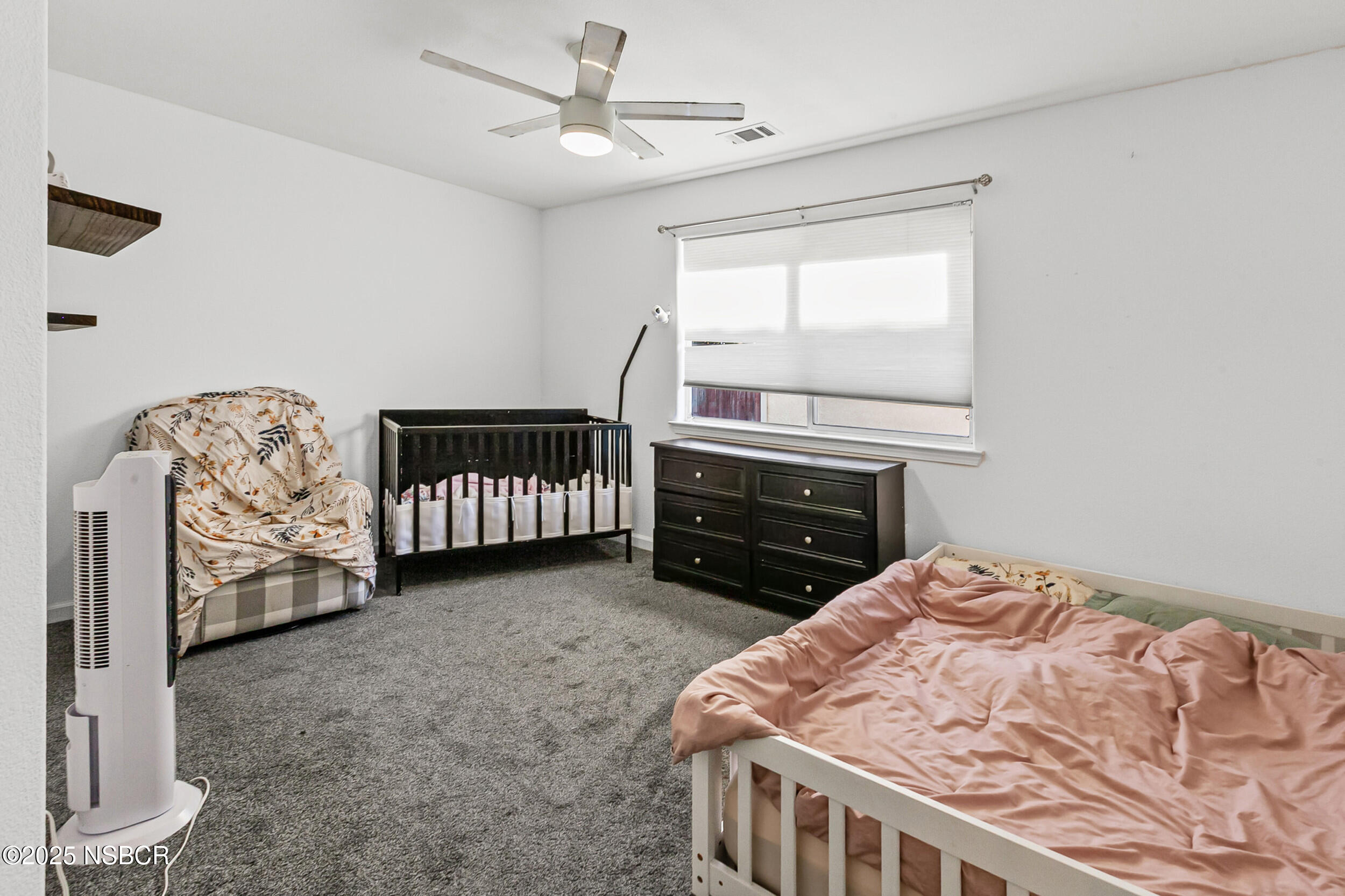 2442 Acacia Street Santa Maria, CA 93458 - Photo 16 of 27 a bed sitting in a room next to a window