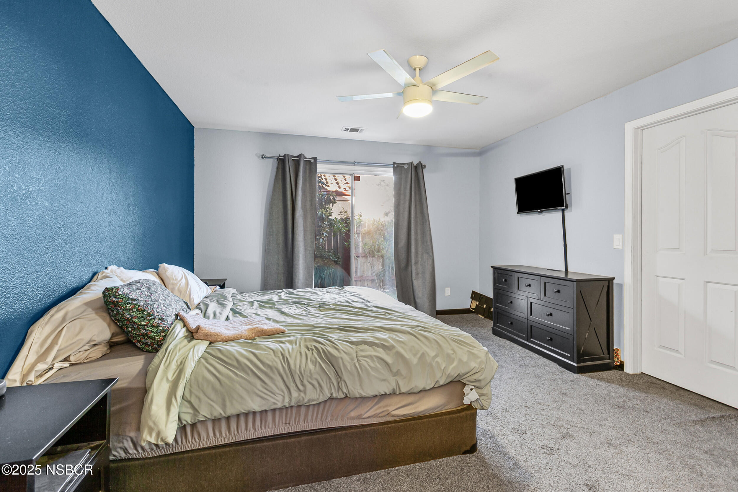 2442 Acacia Street Santa Maria, CA 93458 - Photo 27 of 27 a bedroom with a bed and a flat screen tv