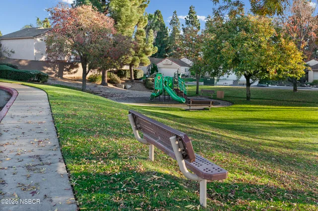 a swimming pool with outdoor seating and yard