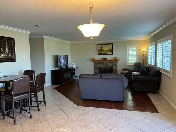 a living room with furniture and a dining table