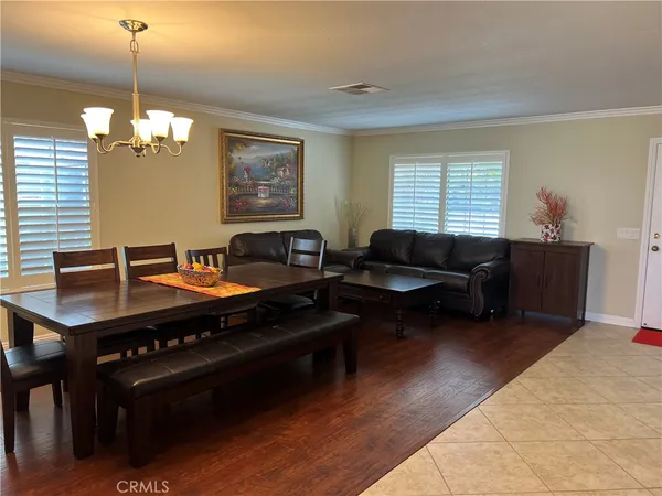 a living room with furniture a piano and a window