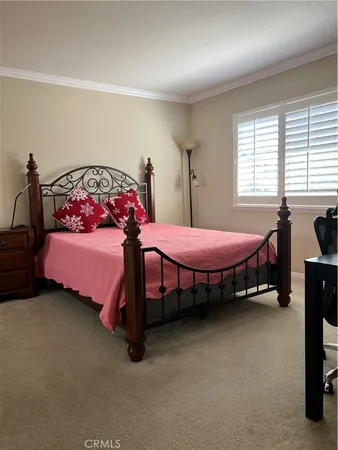 a bedroom with bed and a window