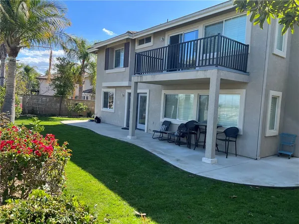 a view of a house with a yard and sitting area