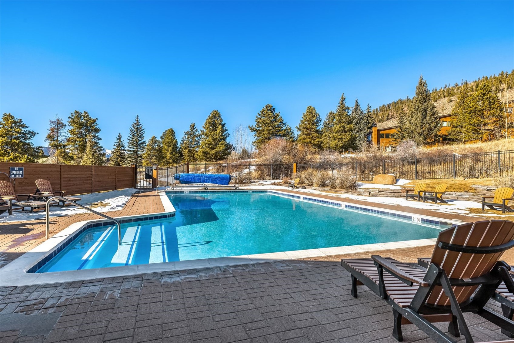 410 Tennis Club Road, Unit 1317 Keystone, CO 80435 - Photo 24 of 42 a view of swimming pool with seating area and trees in the background