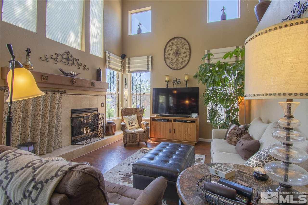 9621 Apache Rose Court Reno, NV 89521 - Photo 11 of 25 a living room with furniture a fireplace and a flat screen tv