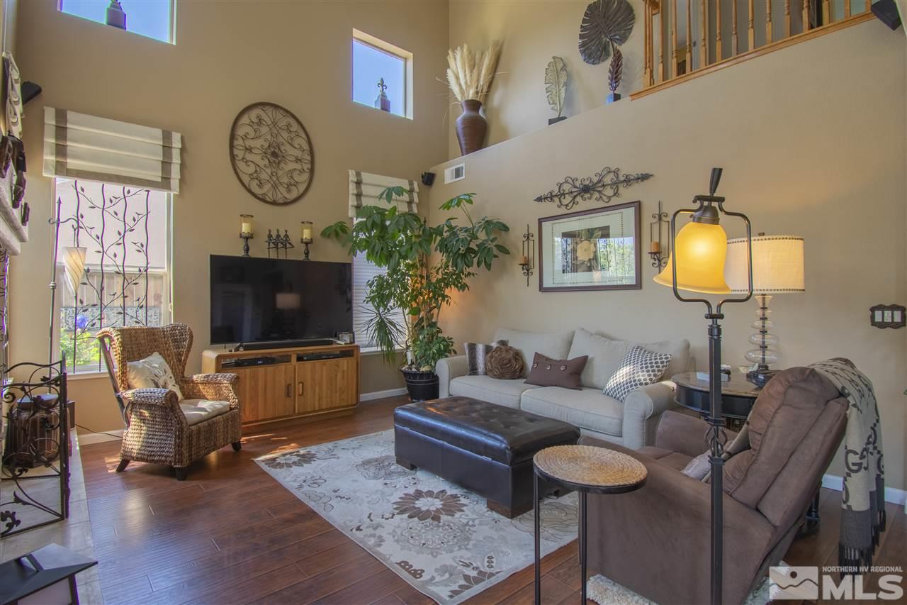 9621 Apache Rose Court Reno, NV 89521 - Photo 12 of 25 a living room with furniture a flat screen tv and a fireplace