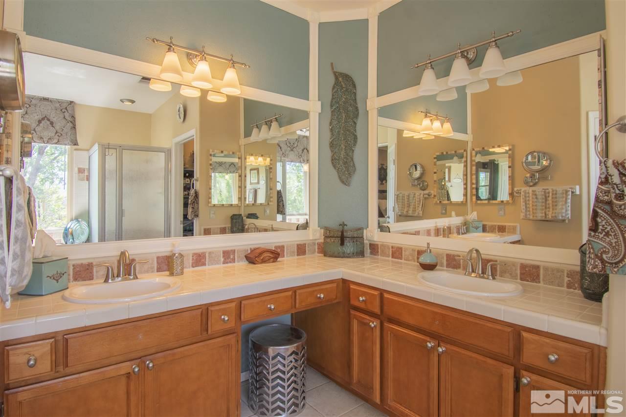 9621 Apache Rose Court Reno, NV 89521 - Photo 16 of 25 a bathroom with a sink and a mirror