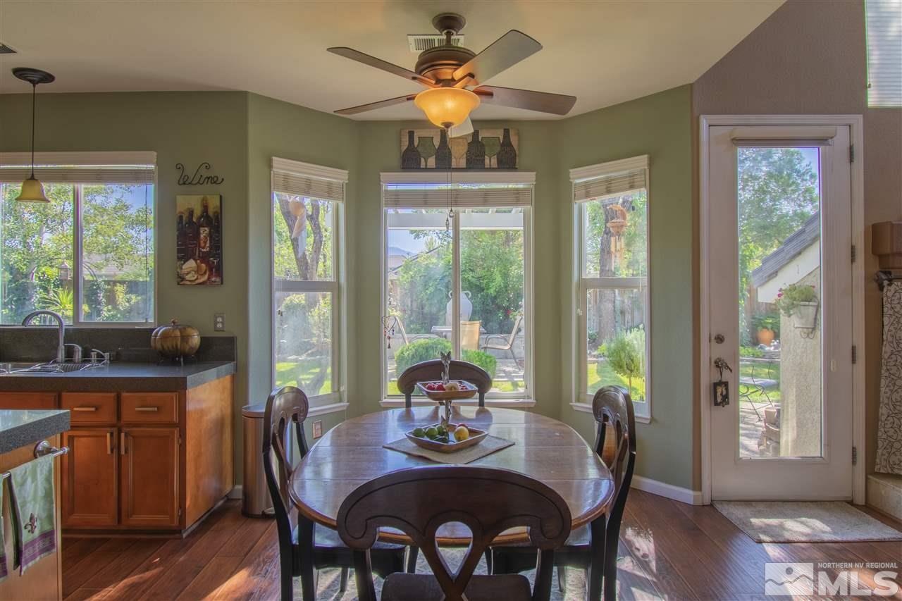 9621 Apache Rose Court Reno, NV 89521 - Photo 10 of 25 a view of a dining room with furniture a chandelier and wooden floor