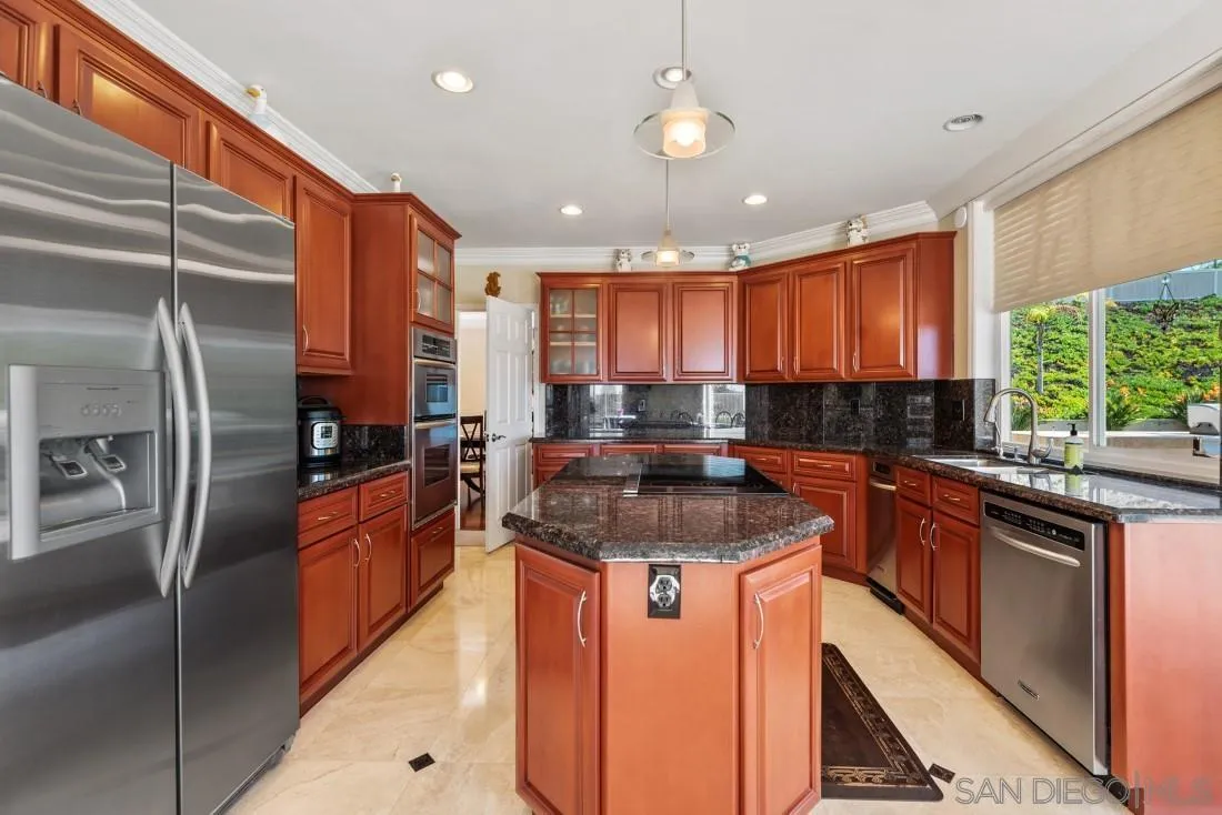 14513 Wildgrove Road Poway, CA 92064 - Photo 12 of 39 a kitchen with stainless steel appliances granite countertop a sink a stove and a refrigerator