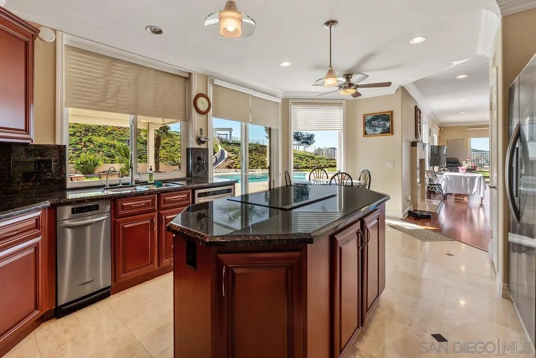 14513 Wildgrove Road Poway, CA 92064 - Photo 13 of 39 a kitchen with stainless steel appliances granite countertop a sink stove and refrigerator