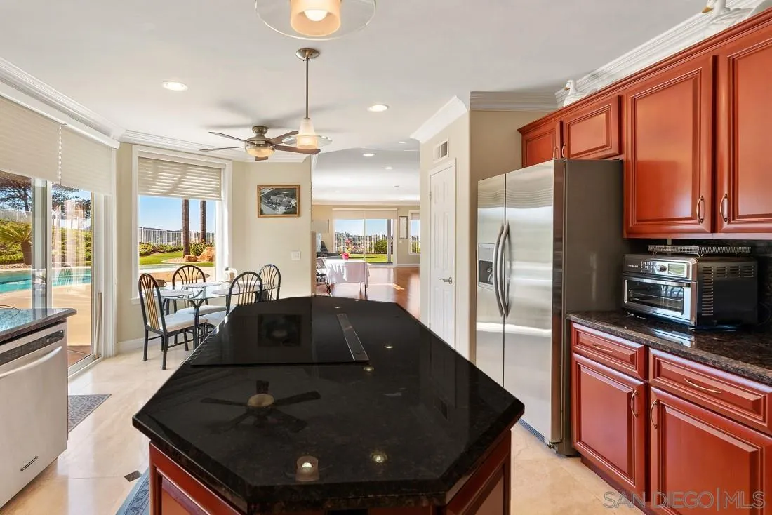 14513 Wildgrove Road Poway, CA 92064 - Photo 15 of 39 a kitchen with stainless steel appliances granite countertop a sink a stove and a refrigerator