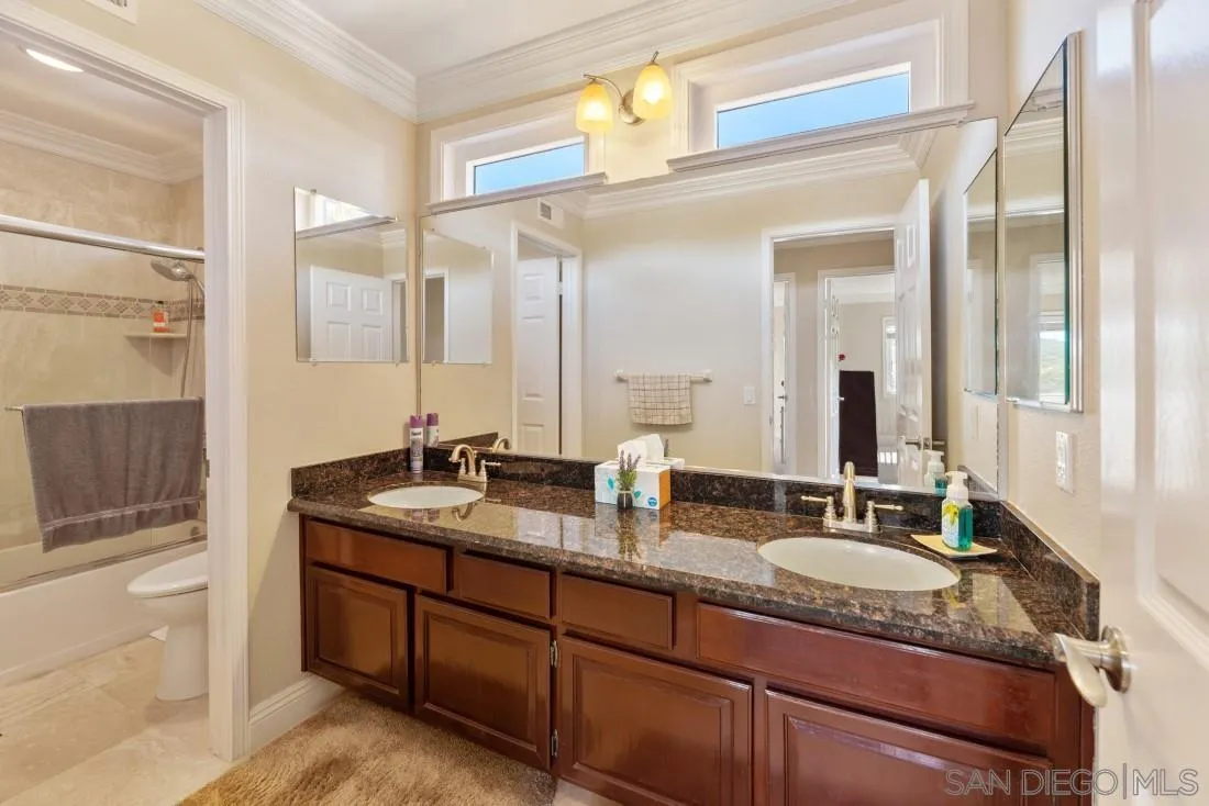 14513 Wildgrove Road Poway, CA 92064 - Photo 27 of 39 a bathroom with double vanity sinks double vanity and a shower