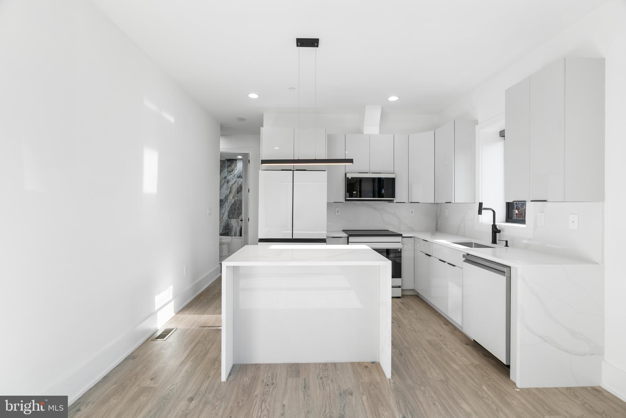 1140 Oates Street Northeast, Unit 102 Washington, DC 20002 - Photo 16 of 40 a kitchen with appliances a sink and cabinets