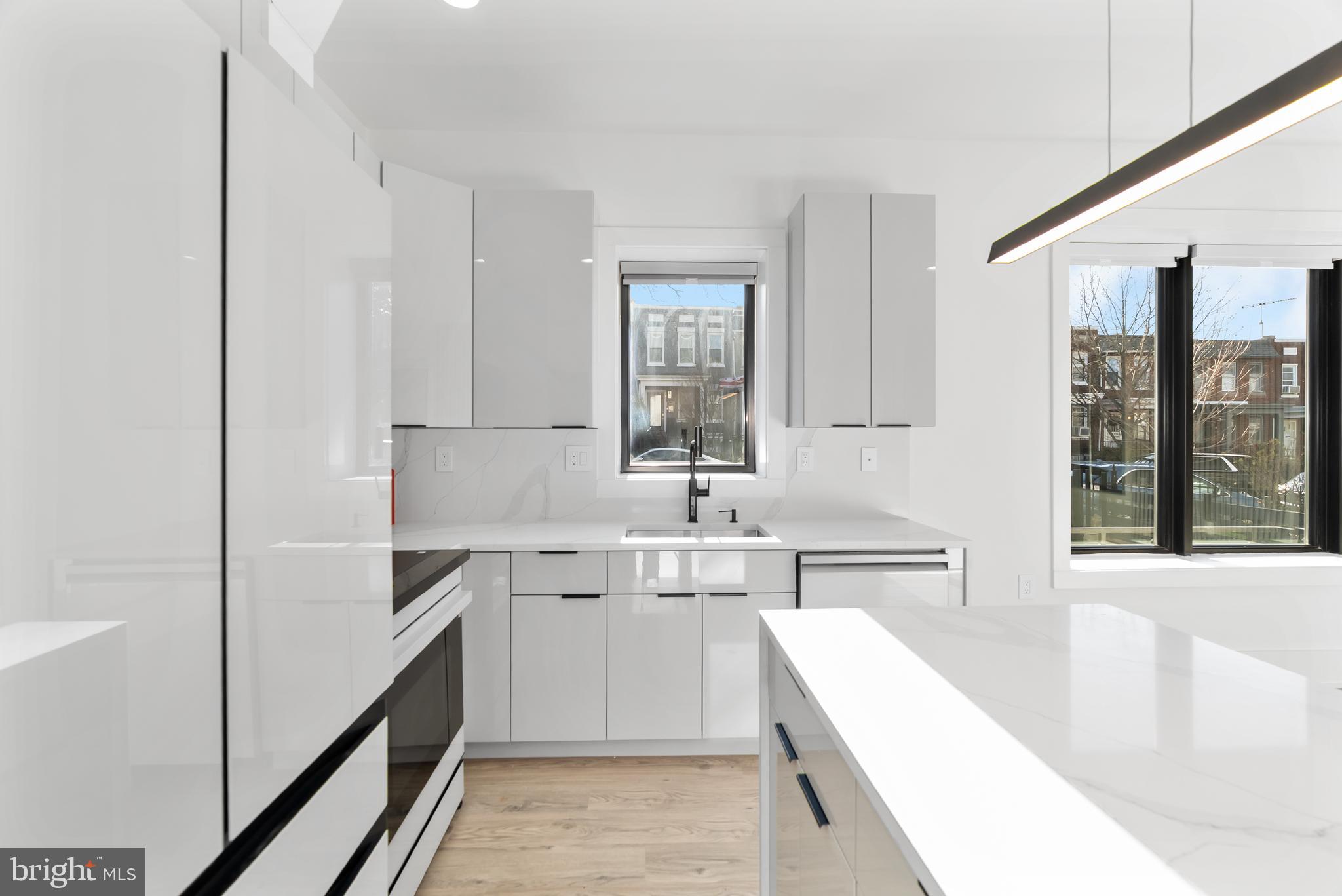 1140 Oates Street Northeast, Unit 102 Washington, DC 20002 - Photo 17 of 40 a kitchen with a sink stove and cabinets