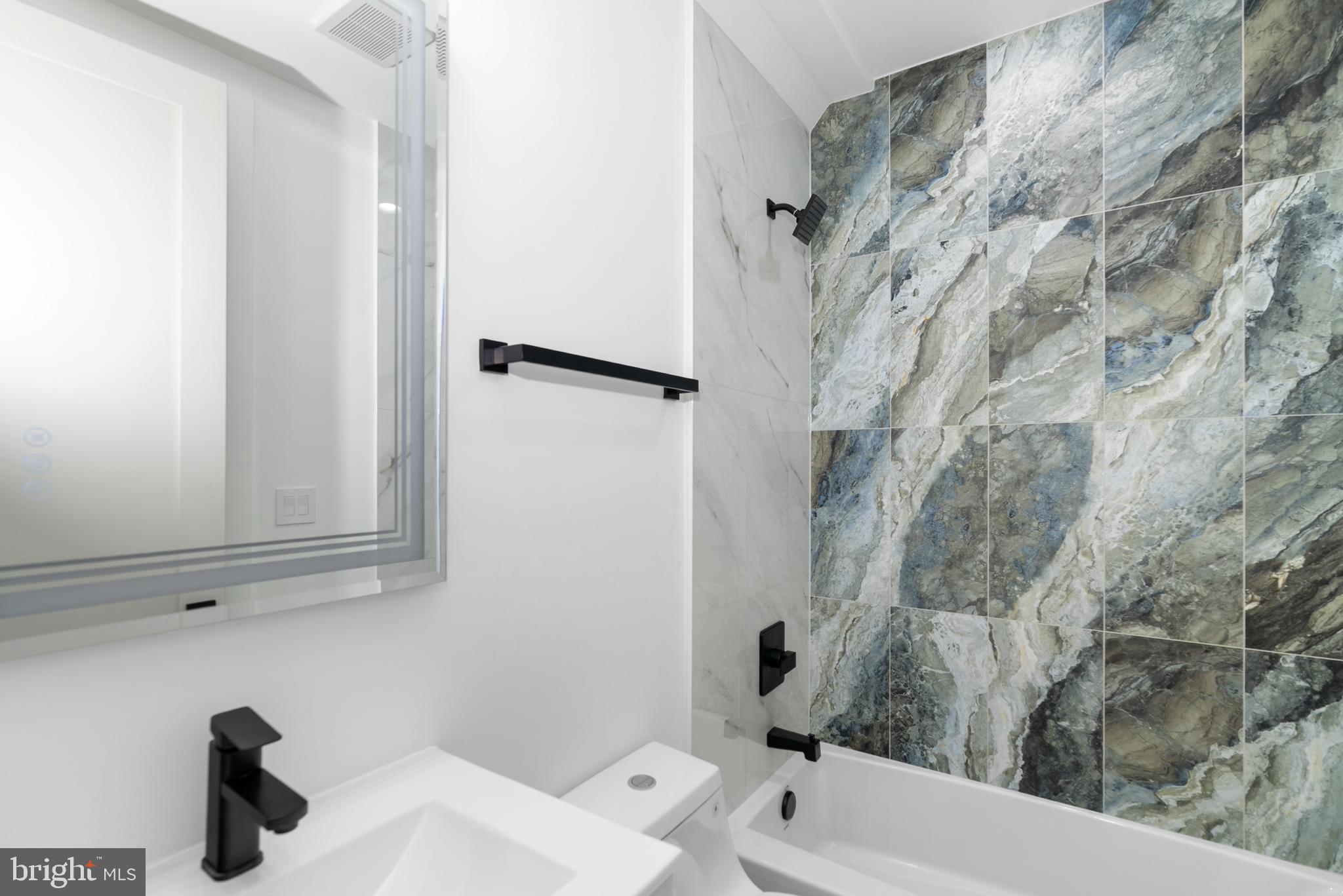 1140 Oates Street Northeast, Unit 102 Washington, DC 20002 - Photo 19 of 40 a bathroom with a sink and a toilet