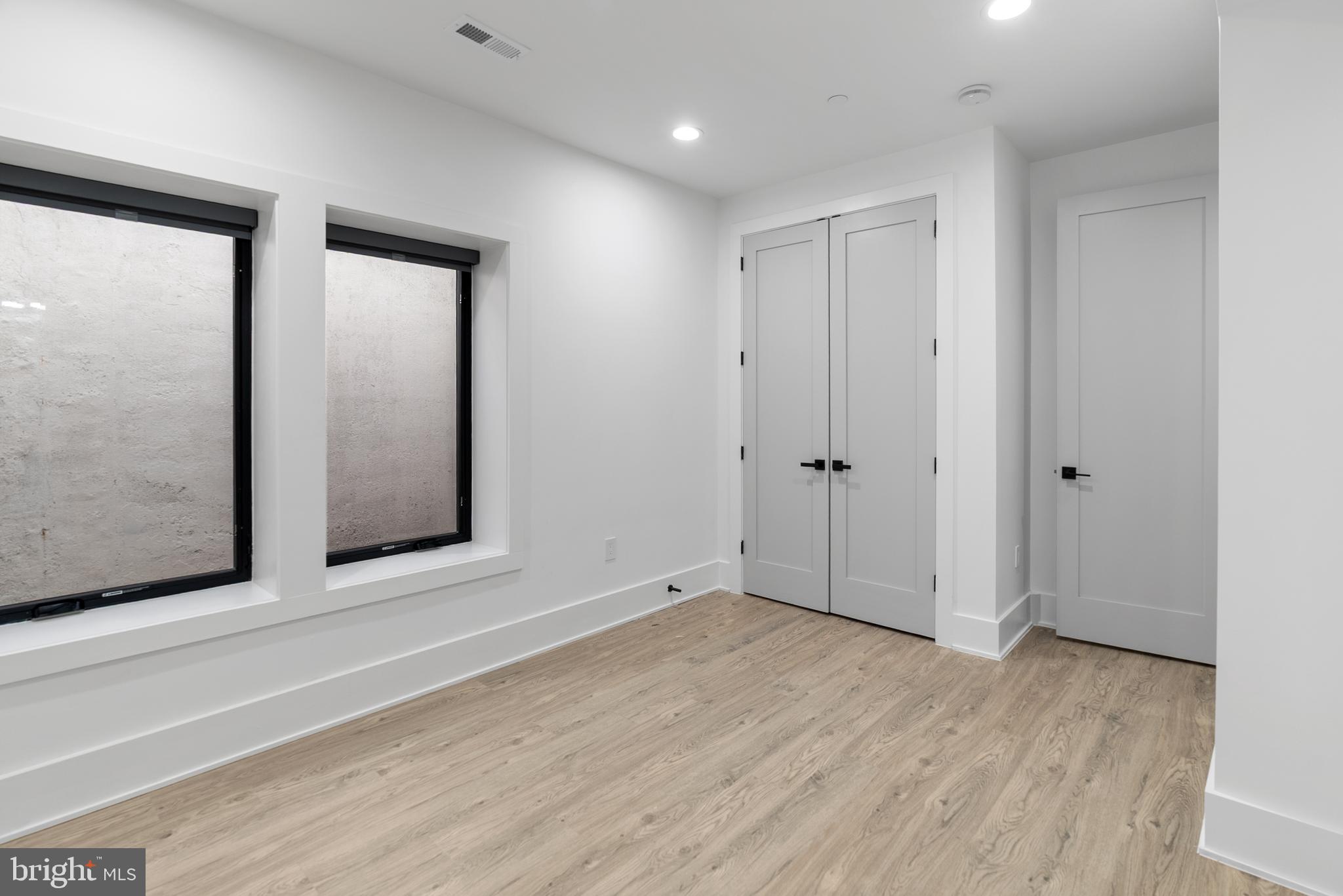 1140 Oates Street Northeast, Unit 102 Washington, DC 20002 - Photo 26 of 40 a view of an empty room with wooden floor and closet
