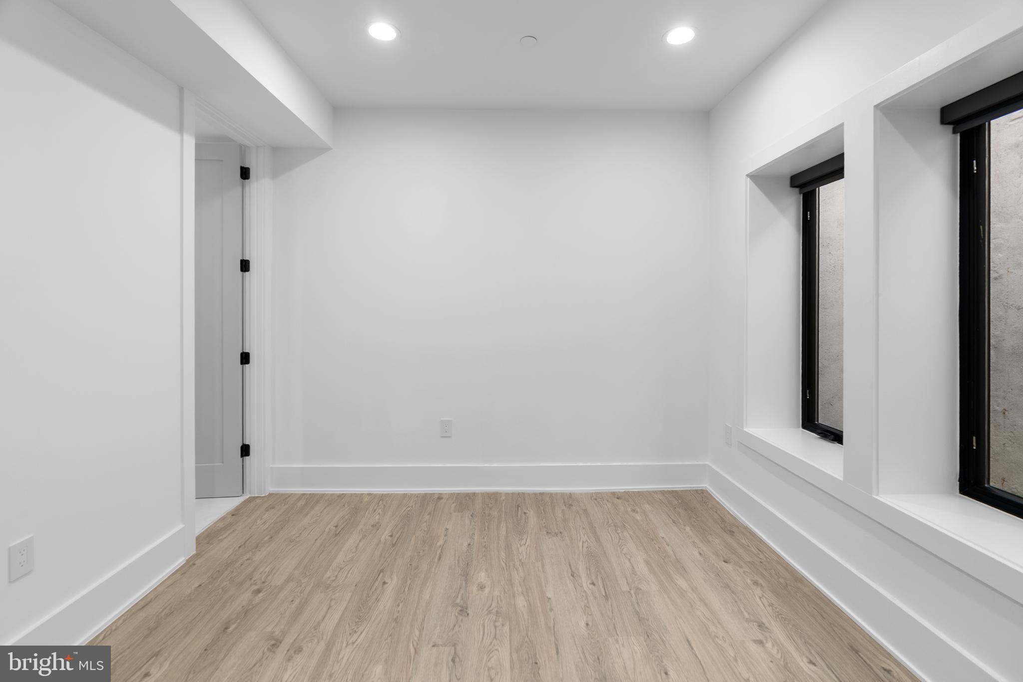 1140 Oates Street Northeast, Unit 102 Washington, DC 20002 - Photo 31 of 40 a view of room with window and hardwood floor