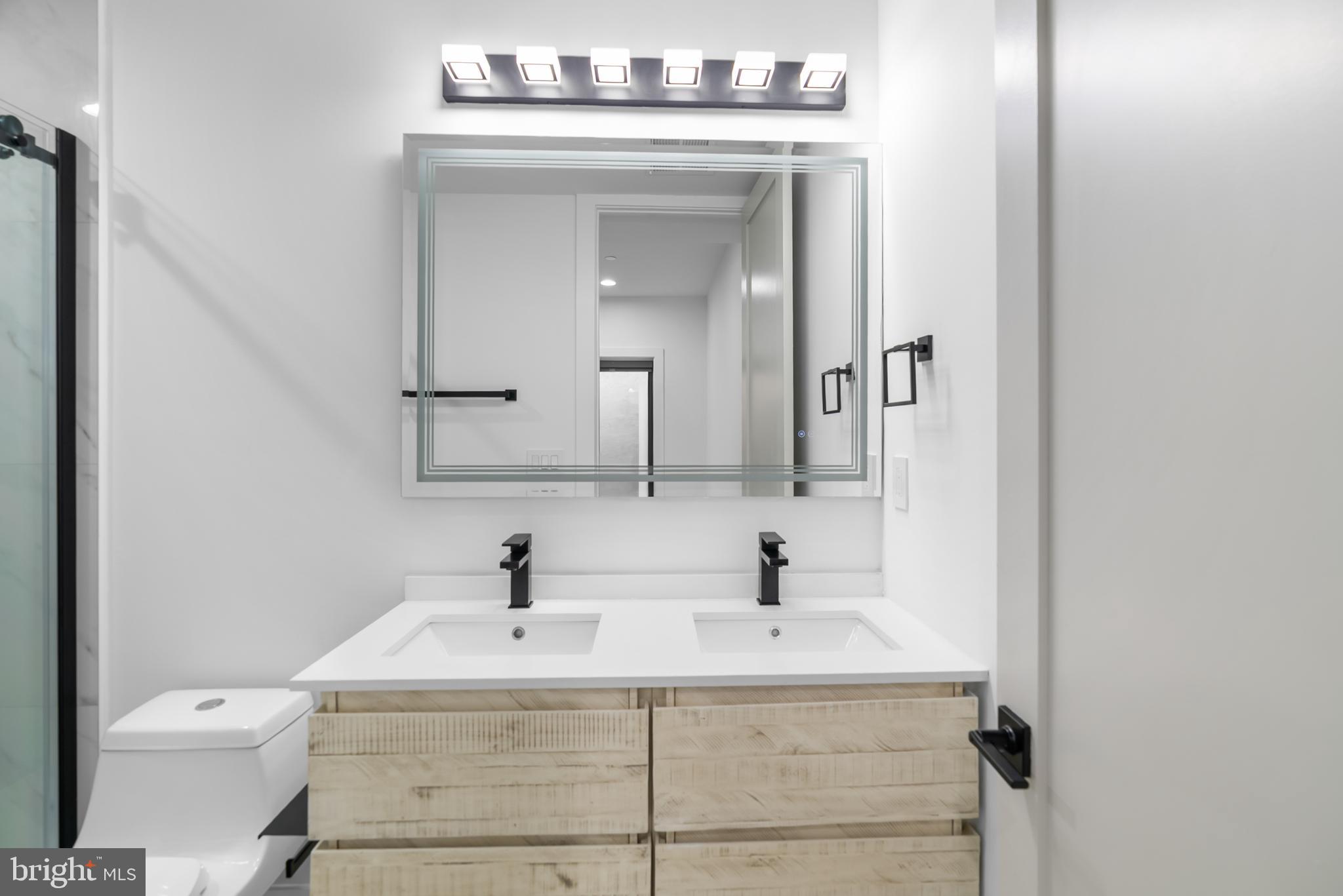 1140 Oates Street Northeast, Unit 102 Washington, DC 20002 - Photo 34 of 40 a bathroom with a sink and a toilet