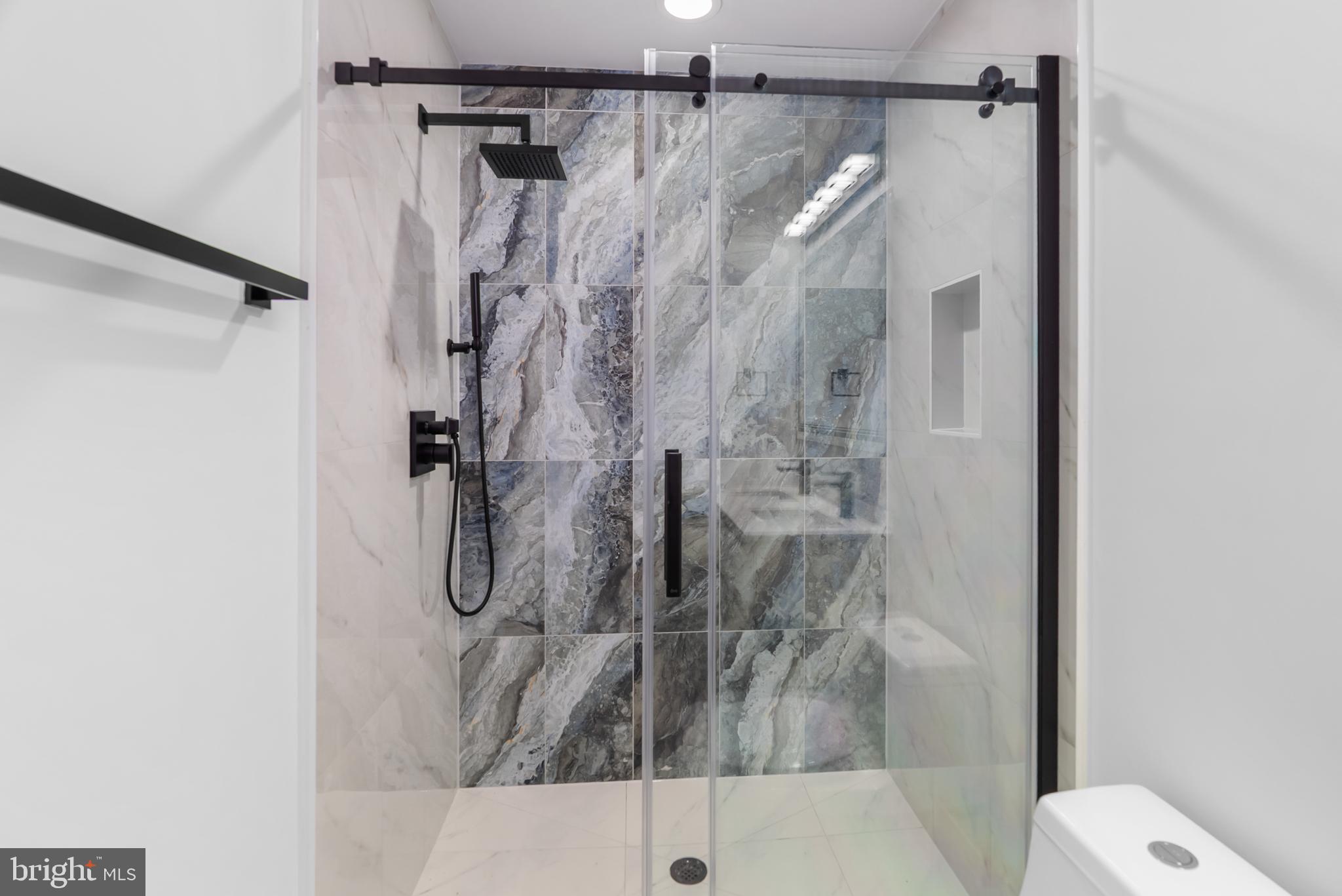 1140 Oates Street Northeast, Unit 102 Washington, DC 20002 - Photo 37 of 40 a bathroom with a shower and toilet