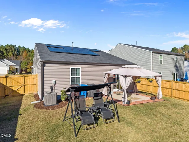a roof deck with table and chairs under an umbrella