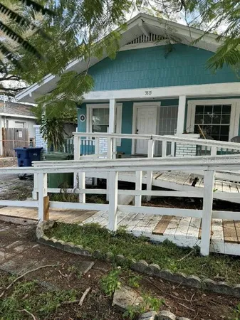 a kitchen with stainless steel appliances kitchen island granite countertop a refrigerator a sink a stove a dining table and chairs